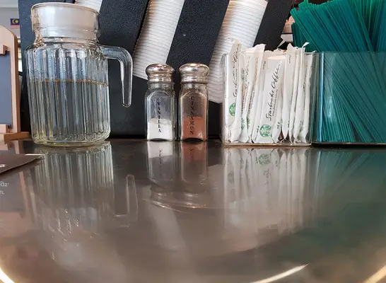 starbucks sweetener cinnamon and straws on table