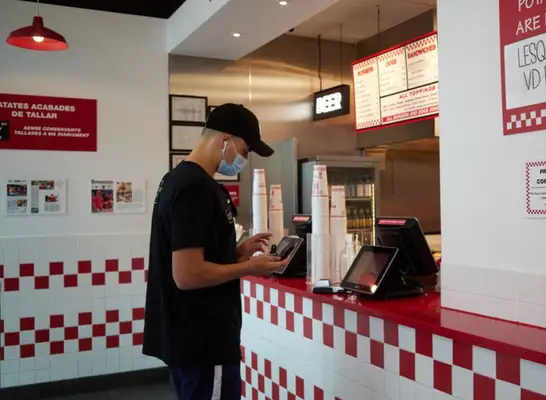 five guys paying at register