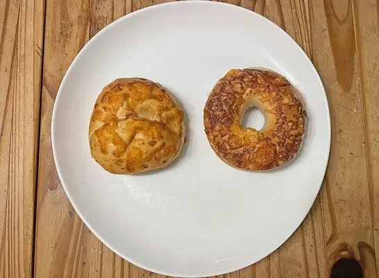 A pair of cheese-flavored bagels from Panera Bread (left) and Einstein Bros. (right)
