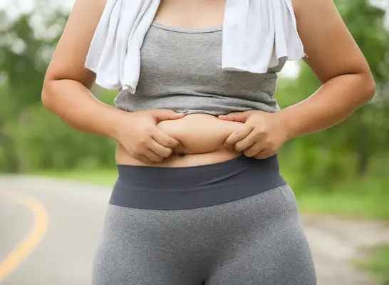 woman holding belly fat, concept of reasons you