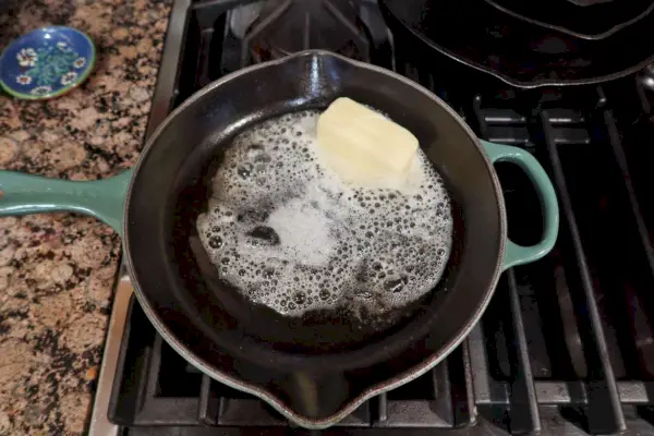 Butter schmelzen in einer emaillierten Gusseisenpfanne von Le Creuset Classic